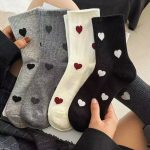 5-pair bundle of neutral-toned ribbed crew socks featuring minimalist heart patterns in black, grey, and cream.