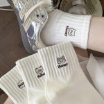 5-pair pack of white ribbed crew socks with cat and bow embroidery.