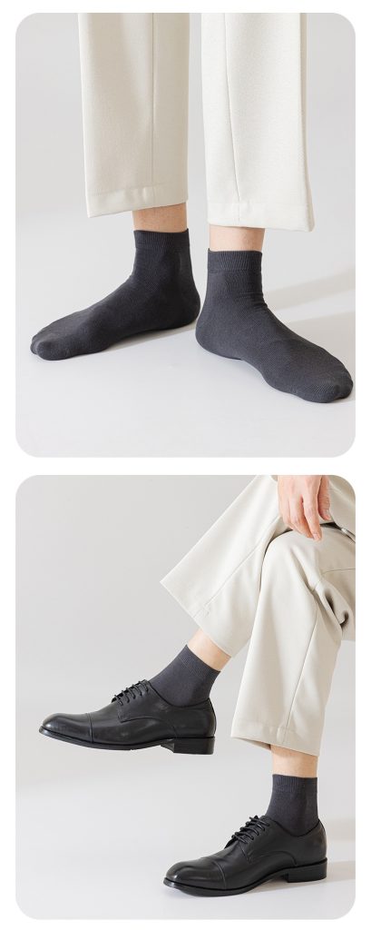 A lifestyle shot showing dark gray Men's Mid-Calf Socks paired with trousers and formal dress shoes.