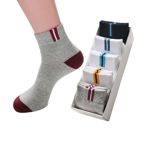 A stylish display of men's in-tube crew socks, with one grey sock being modeled and others neatly packed in a gift box.